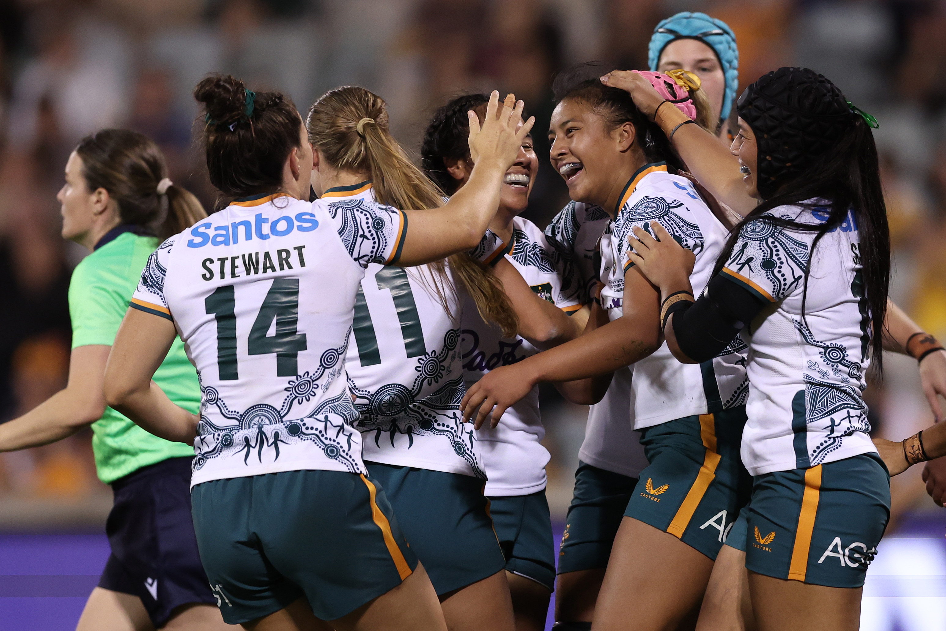 Wallaroos celebrating a try against Scotland